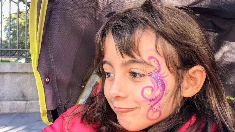 Girl with face paint for Mardi Gras