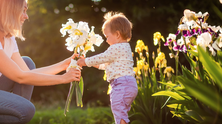 baby girl with a bouquet of irises