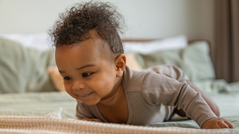 Baby doing tummy time on a bed