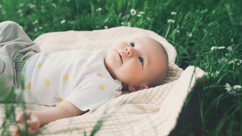 Baby lying in the grass and looking up