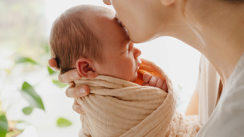 Mom kissing a baby