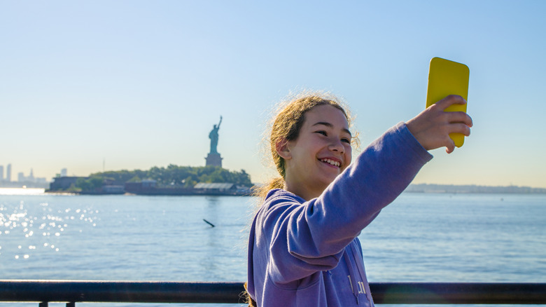 Girl near the Statue of Liberty where the Hudson River ends and empties into