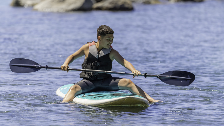 Teen paddle boarding in Lake Tahoe