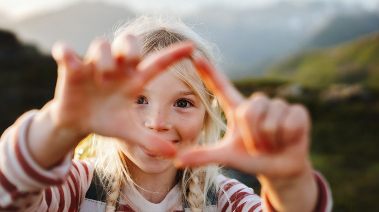 Little girl with blurry mountain range behind her