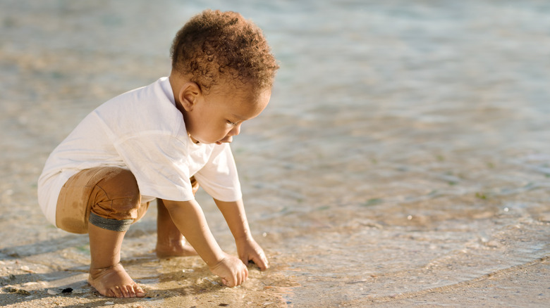 little boy playing in the ocean