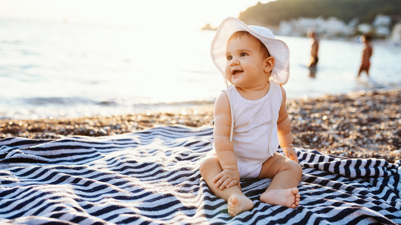 baby girl sitting on the beach