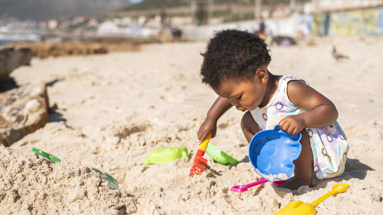 young child playing on the beach