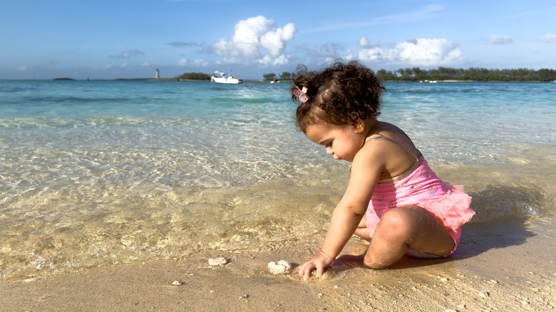 baby girl playing in the sand