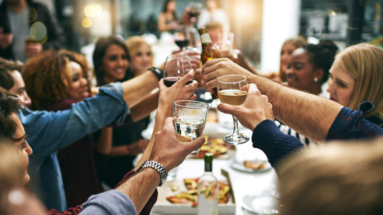 Group toasting around a table at a restaurant