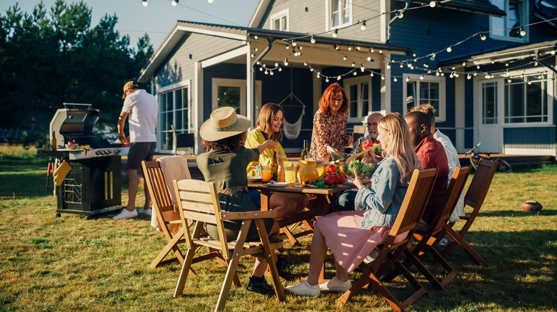 A group enjoys a backyard barbecue baby shower