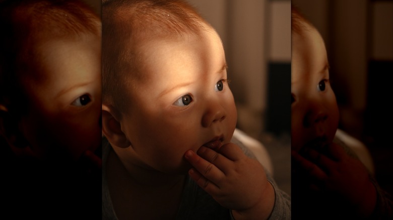 baby with a flash of light outside