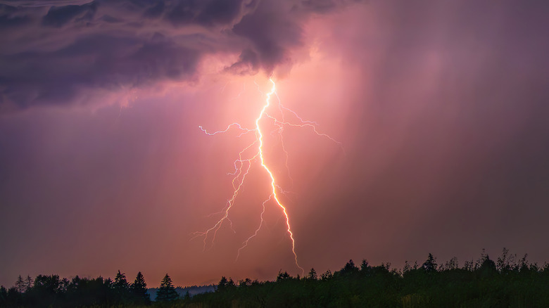 powerful lightning bolt in a pink sky