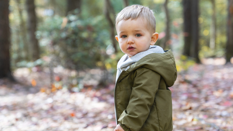little boy in a hunter green jacket