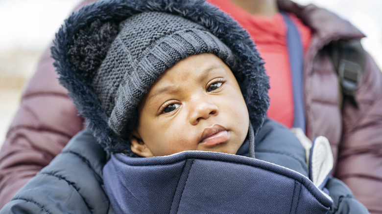 baby wearing an indigo blue hat and coat