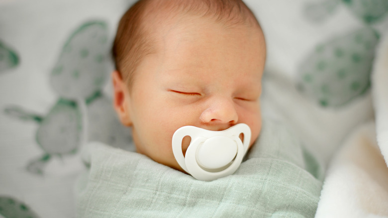 baby wearing sage green