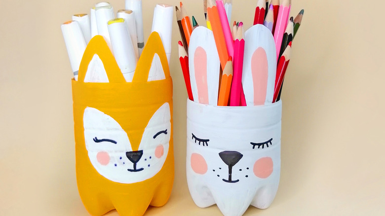 Two plastic bottles are upcycled to adorable craft holders resembling woodland creatures