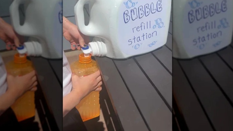 A large laundry detergent jug upcycled into a bubble refill station