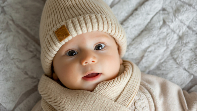 bundled baby boy in winter with neutral colored clothing