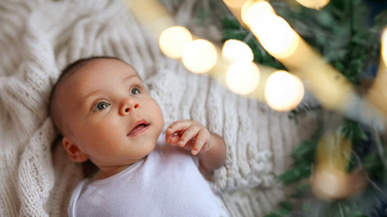 baby boy looking up at twinkling lights