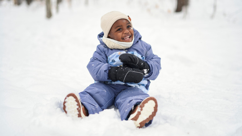 little boy playing in the snow