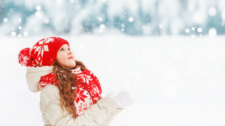 little girl playing in the snow