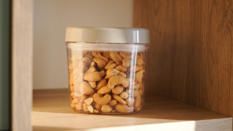 A jar of mixed nuts on a shelf