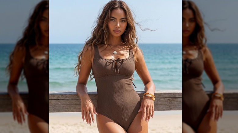 Woman on beach in brown swimsuit