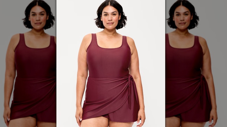 Woman in burgundy one piece swimsuit