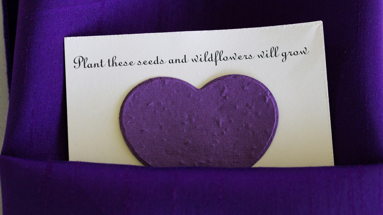 Party favor gift of purple heart with wildflowers inside