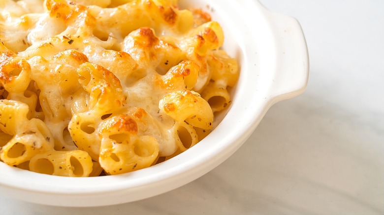 Baked macaroni and cheese in a small white casserole dish