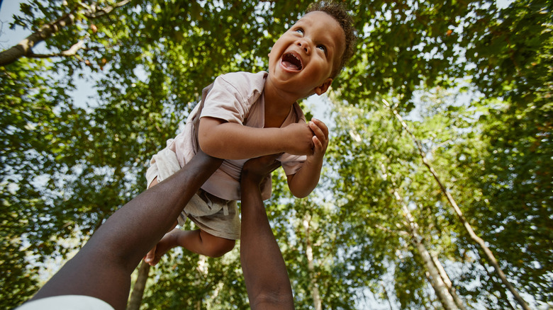 Happy child laughing in the forest