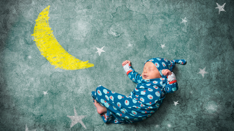 baby with a moon and stars drawing
