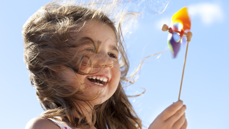 little girl playing in the wind