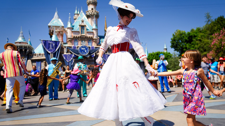 Mary Poppins holding a girl's hand at Disneyland
