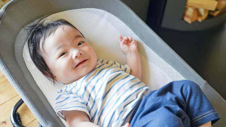Baby sitting in bouncer chair
