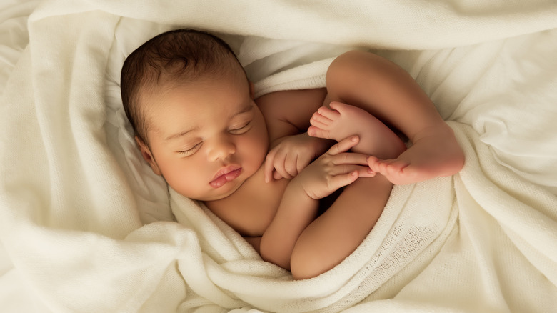 Sleeping baby wrapped in blanked