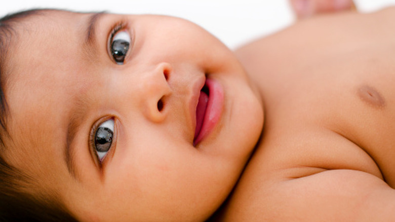 baby girl with bright eyes laying down