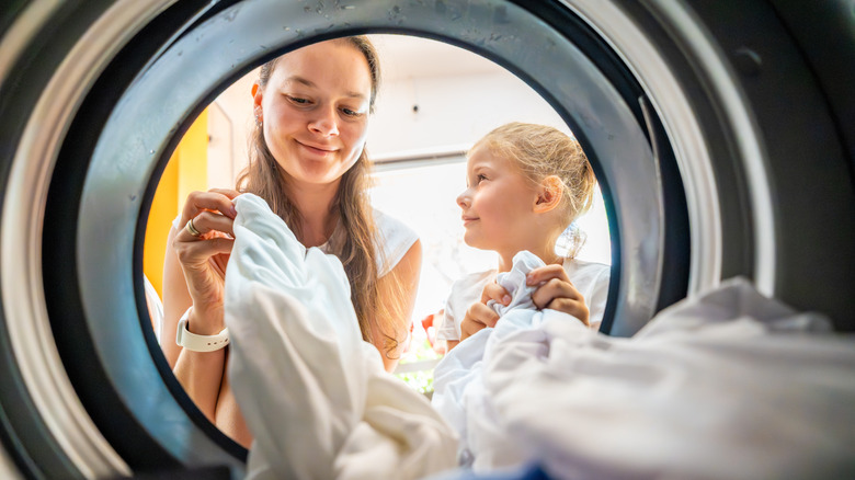 mother and daughter doing laundry together