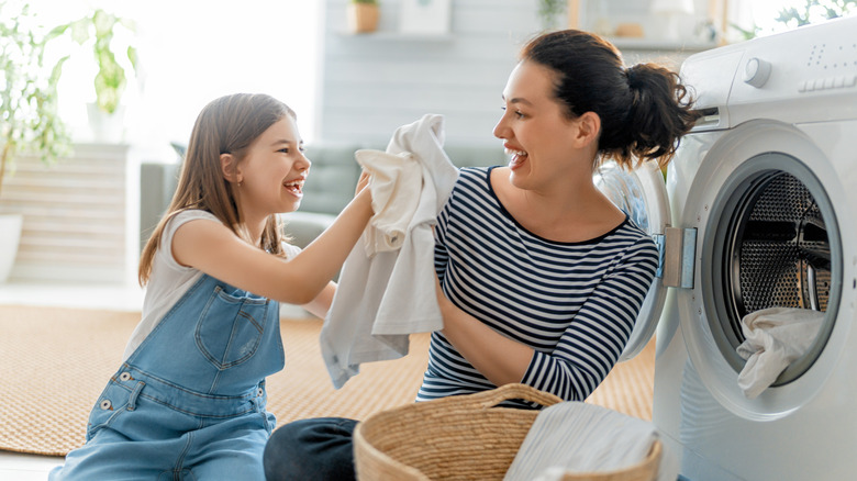 mother and daughter doing laundry
