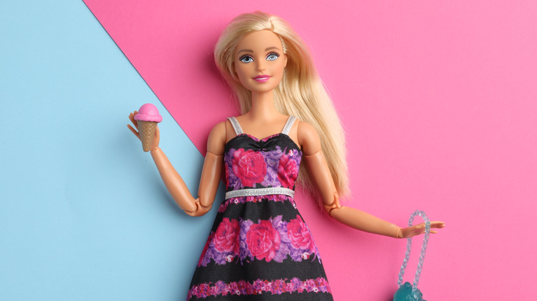 Barbie doll set against and pink and blue background