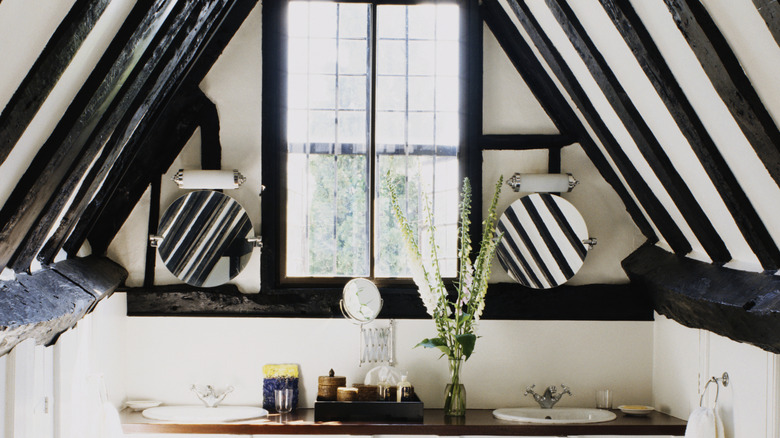 cottage style bathroom with historic wooden beams
