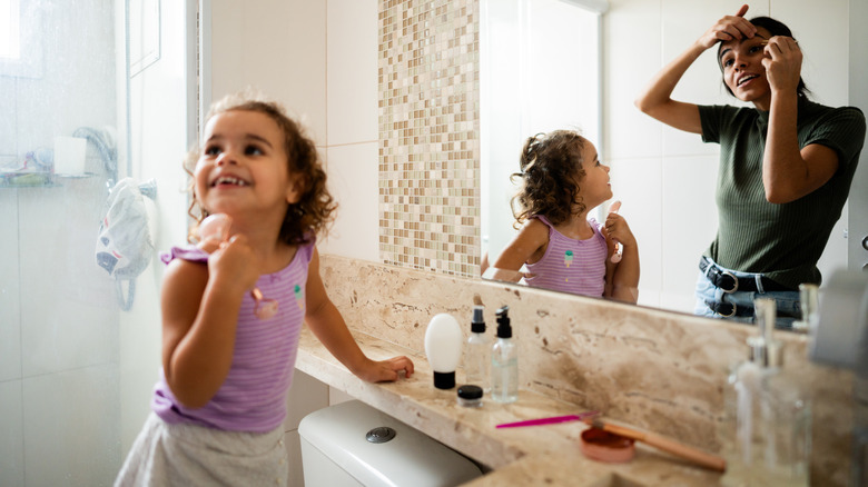 mom and daughter get ready with a small vanity space
