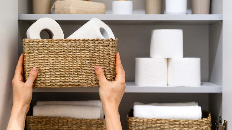 hands organizing bathroom must-haves