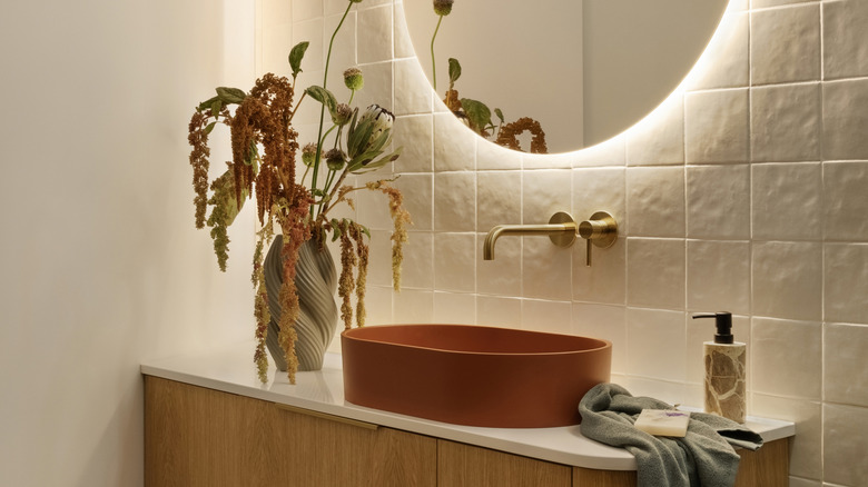 warm neutral bathroom with small vanity and great lighting