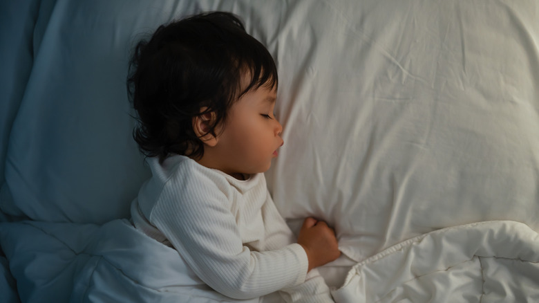 Baby sleeping in a bed