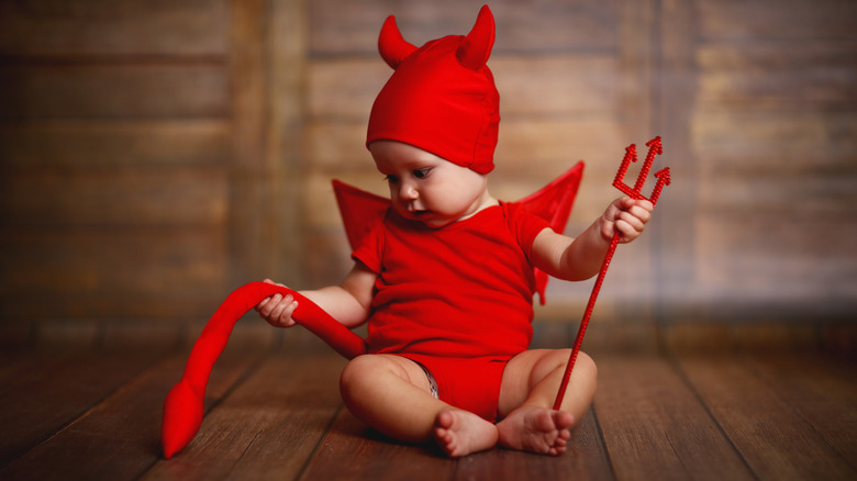 Baby in a red devil costume