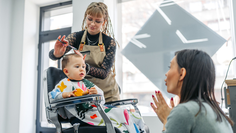 Parent watching child get a haircut