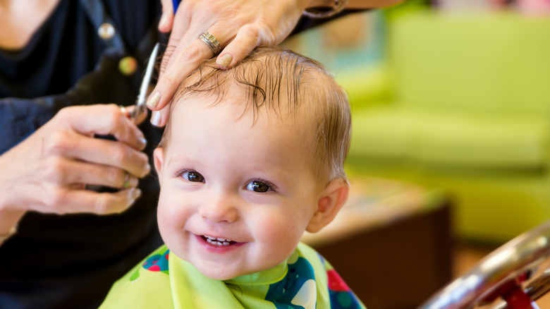 Happy toddler getting a haircut