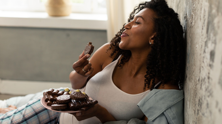 Pregnant woman with plate of sweets