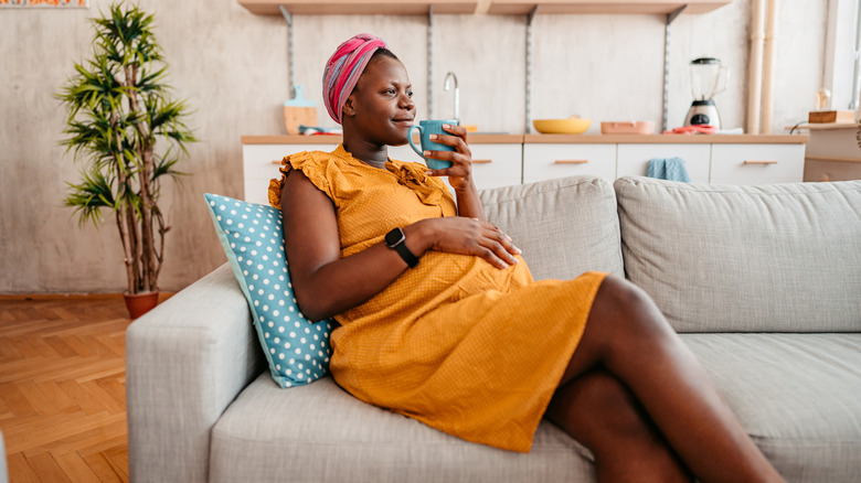 woman relaxing on sofa with coffee